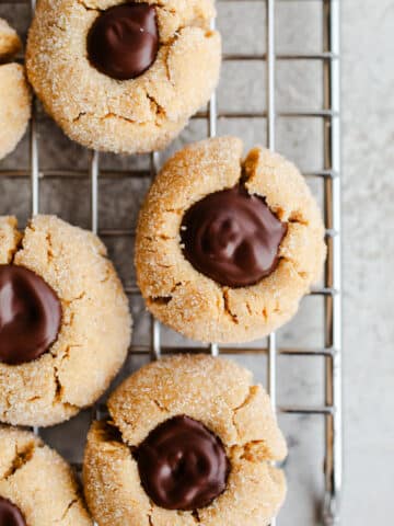 Peanut butter blossoms on a wire rack.