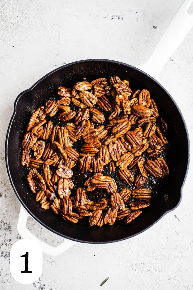 Pecans in a cast iron skillet.