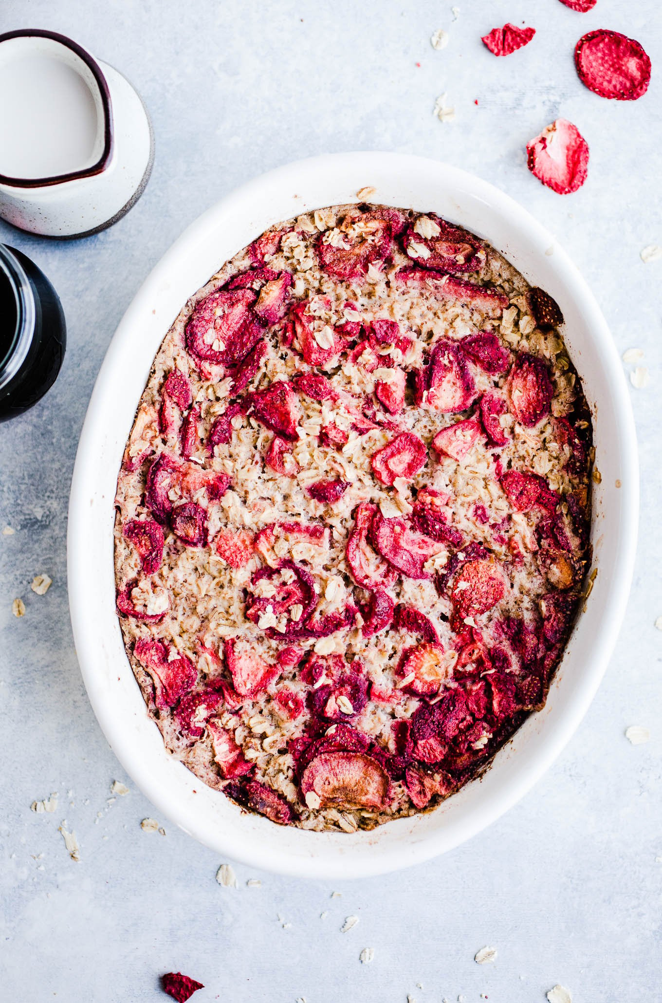 Strawberry Baked Oatmeal in a white oval dish with freeze-dried strawberries.