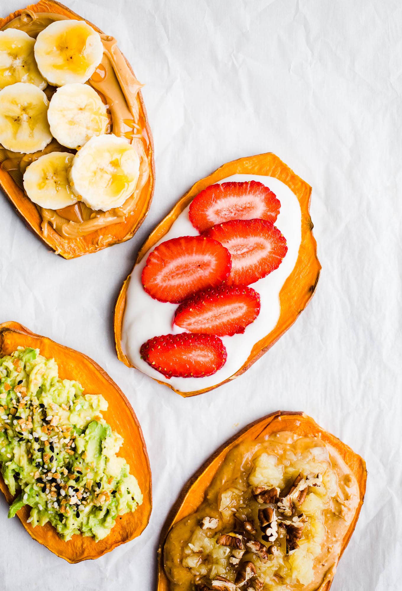 Sweet potato toasts with toppings on parchment paper. 