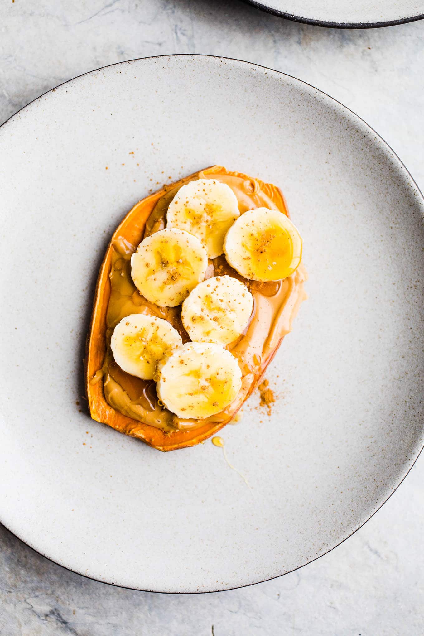 Sweet potato slice topped with peanut butter and bananas.