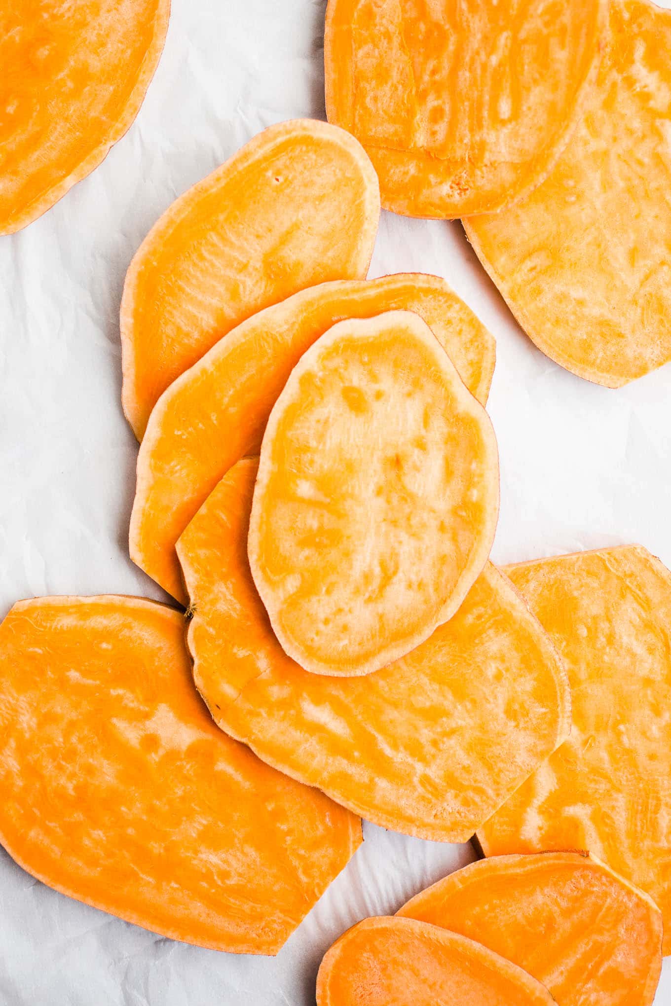 Sweet potato slices on parchment paper. 