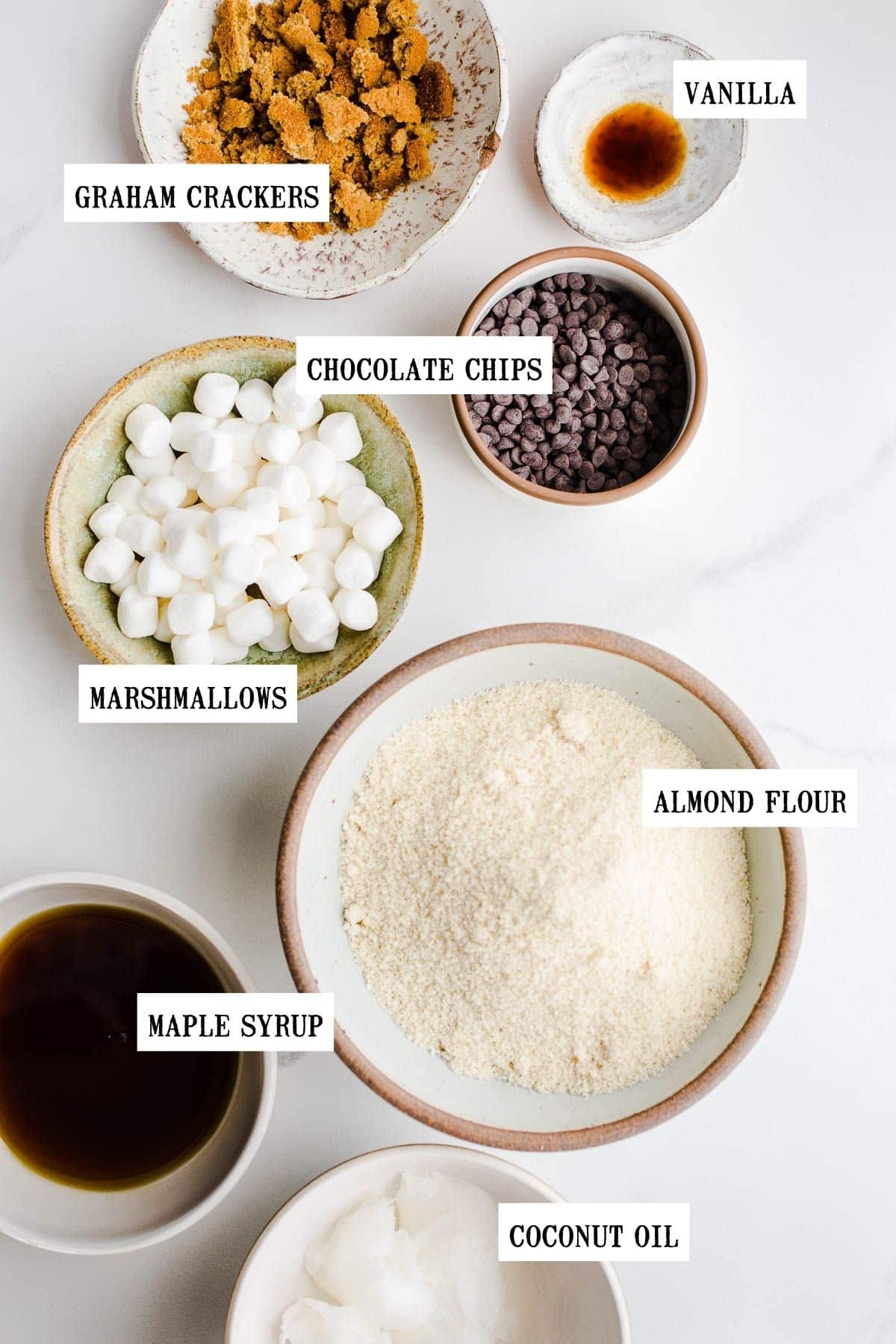 Ingredients to make chocolate marshmallow cookies  in small bowls.