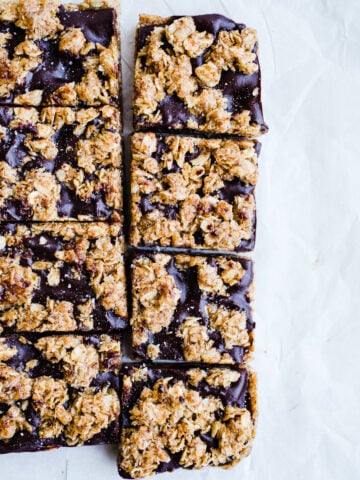 Chocolate oatmeal squares on a piece of parchment paper.