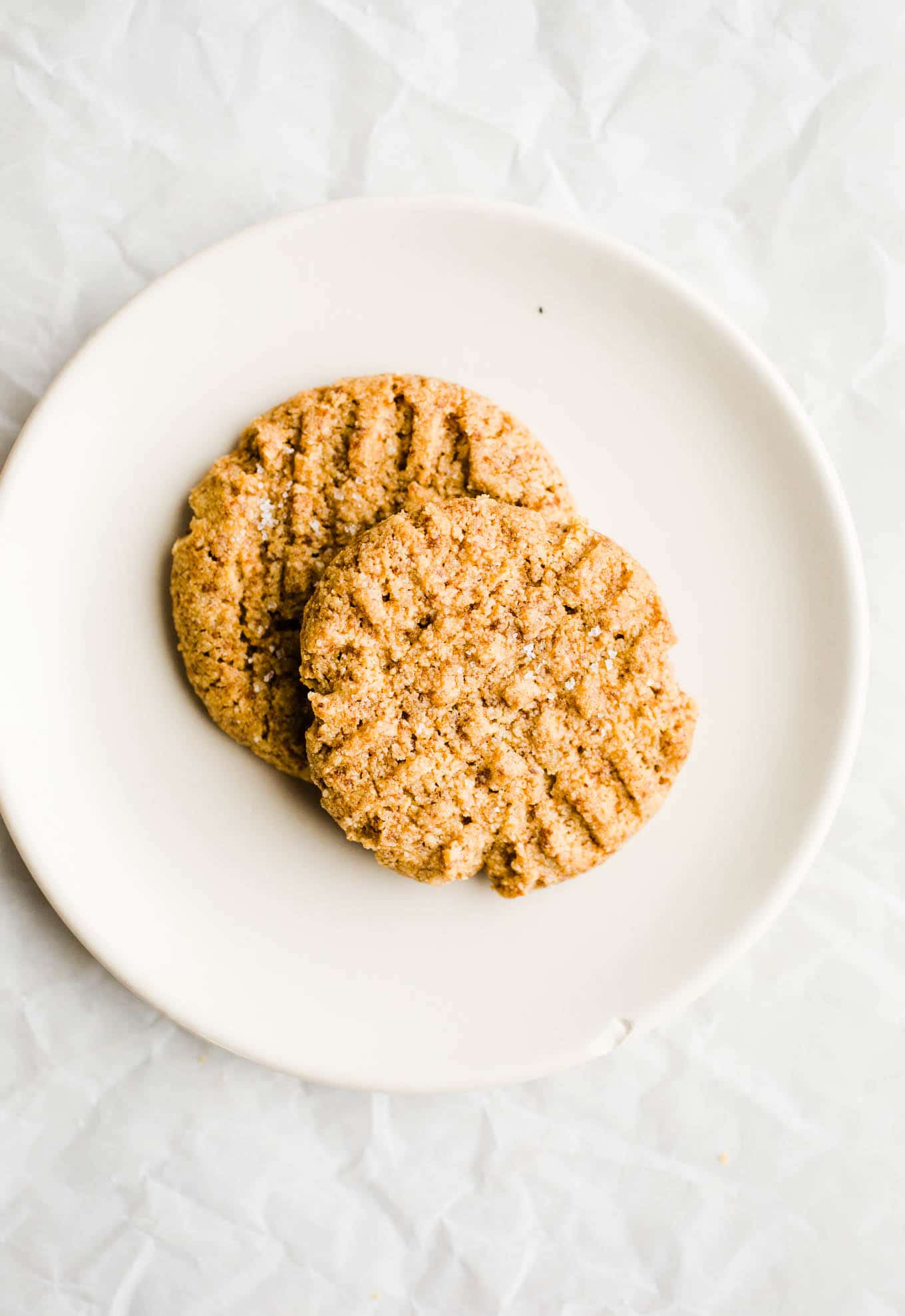 Two cookies on a white plate. 