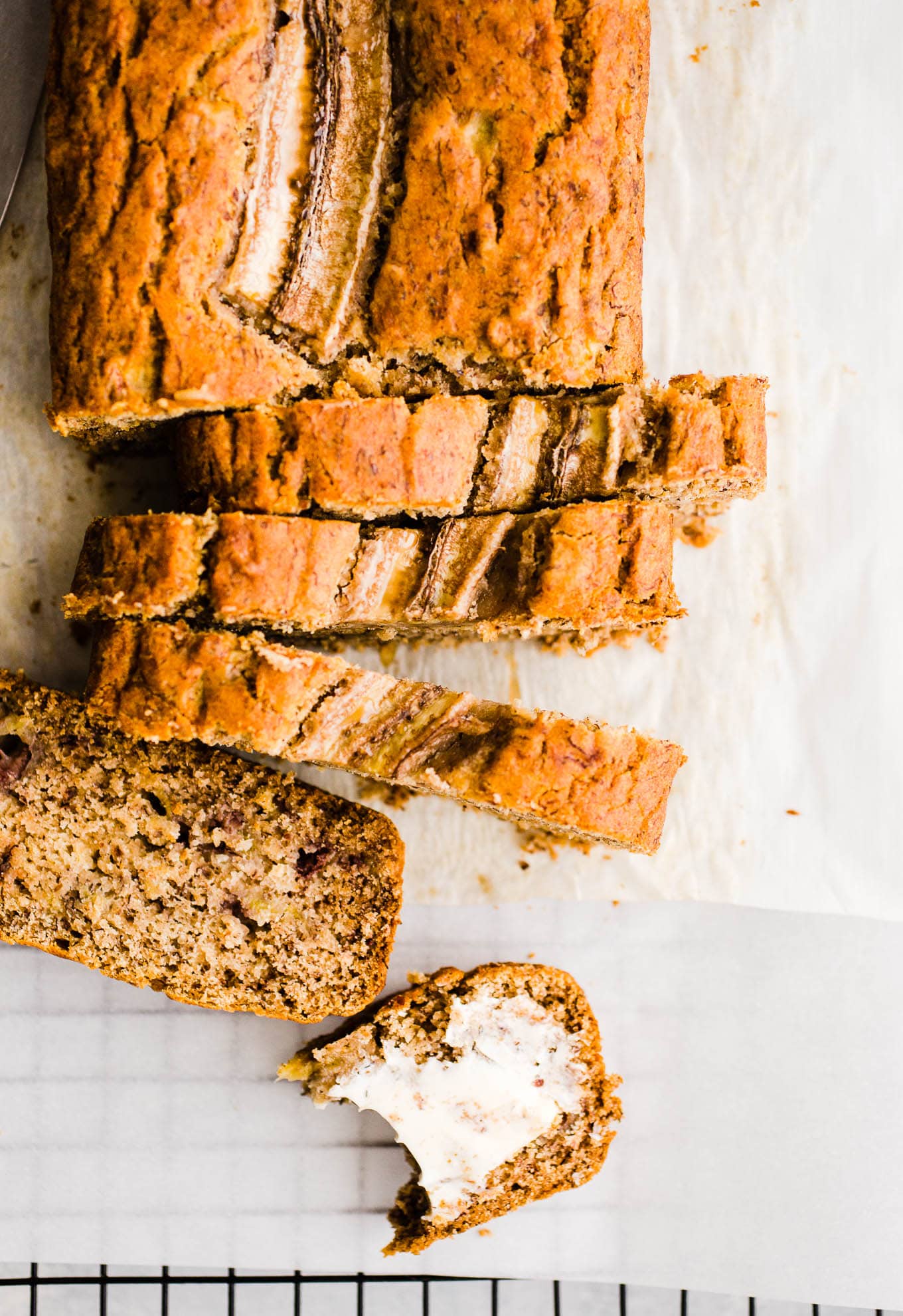 A full loaf of quick bread partially cut into slices.