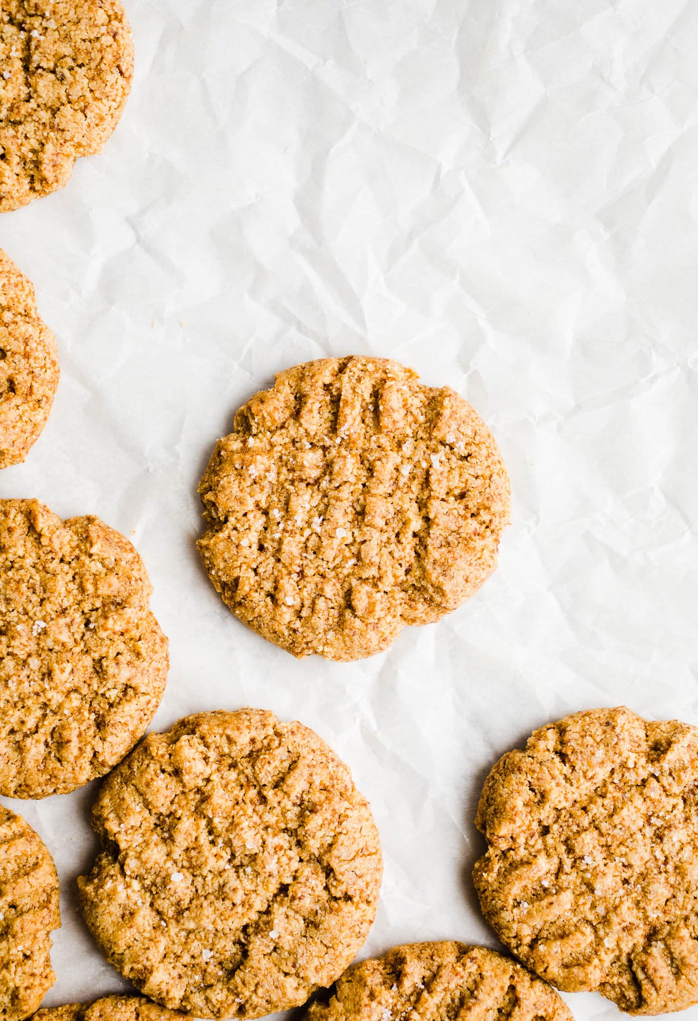 Peanut butter cookies on parchment paper.