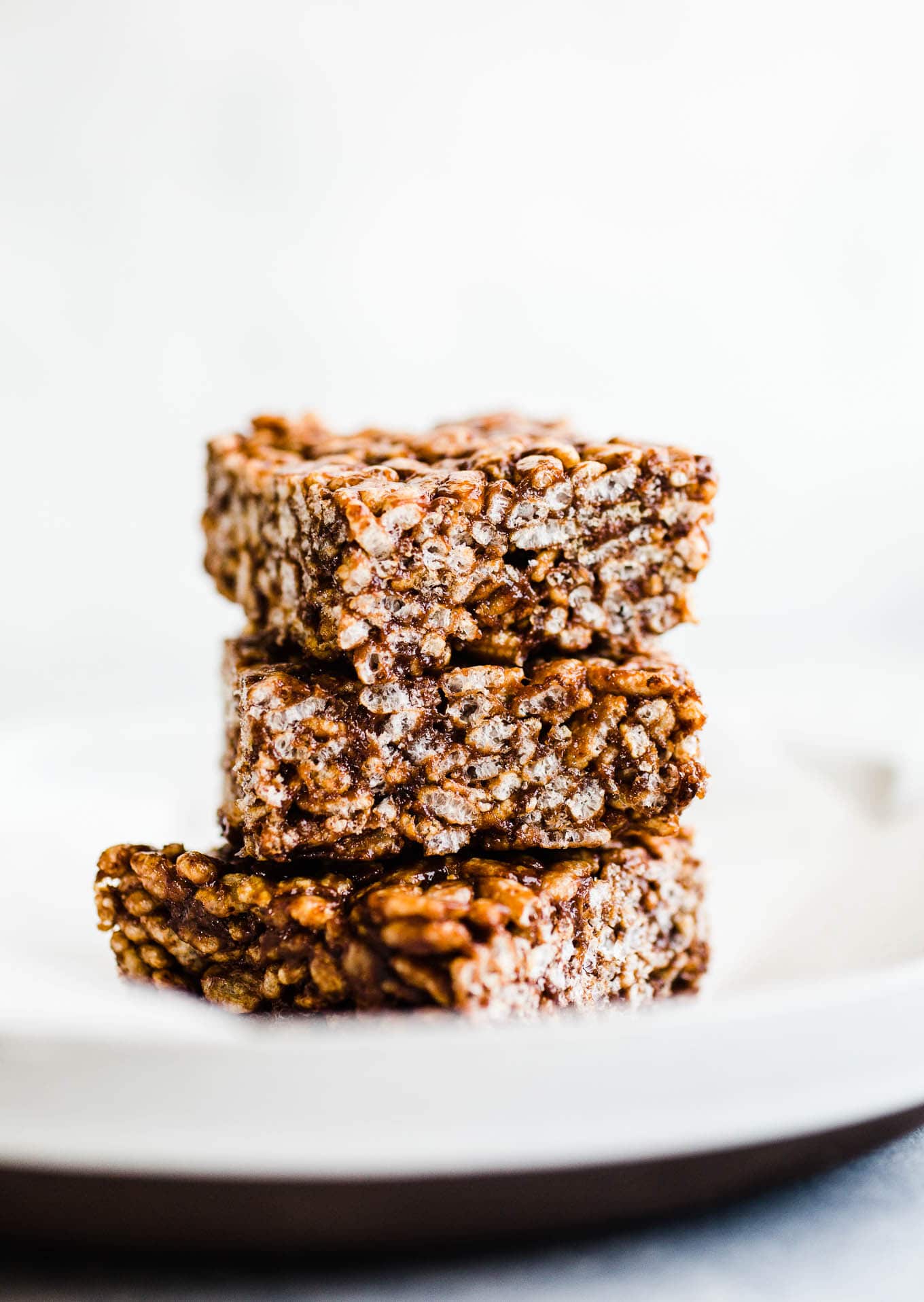 A stack of cereal treats on a piece of parchment paper. 