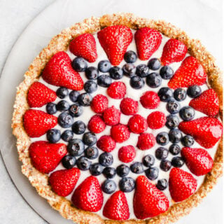 A fruit tart on a marble platter.