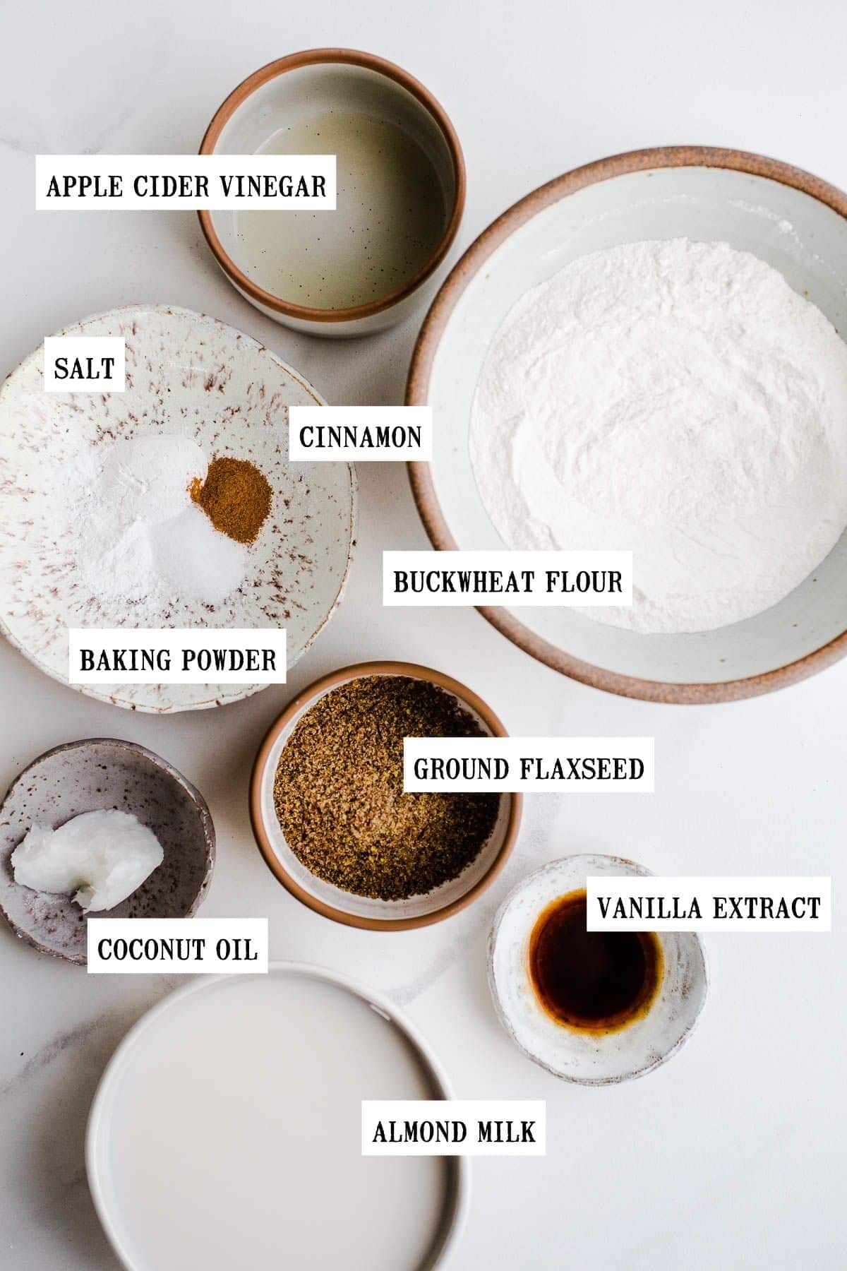 Ingredients to make pancakes in small bowls.