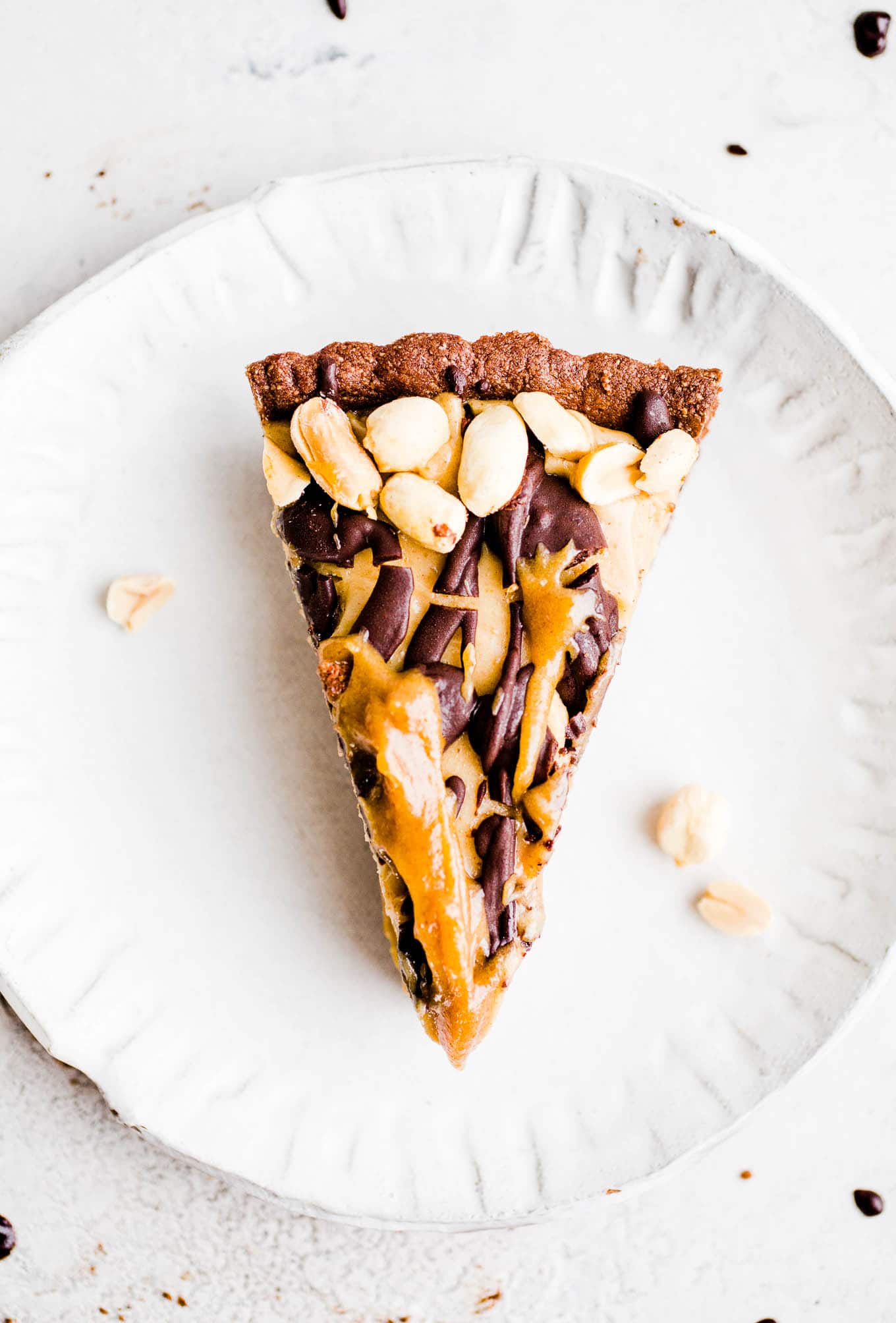 slice of pie with peanuts, chocolate, and caramel