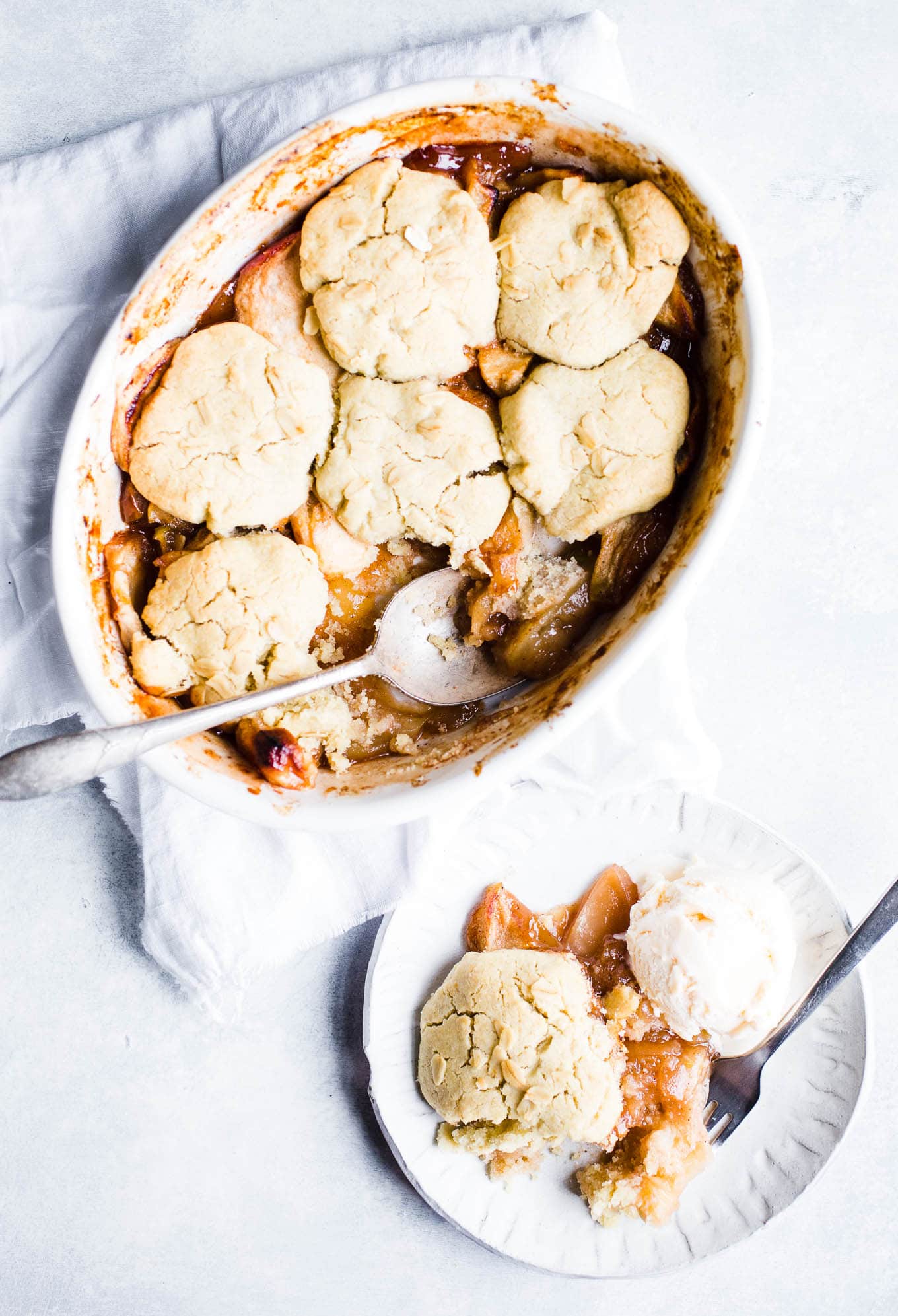 An apple cobbler dessert in an oval baking dish.