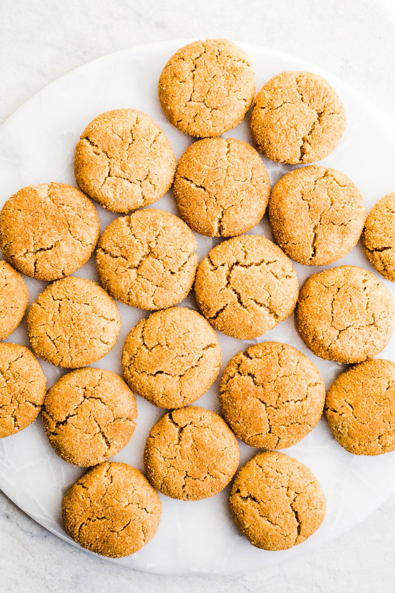 Pumpkin cookies on a white platter. 