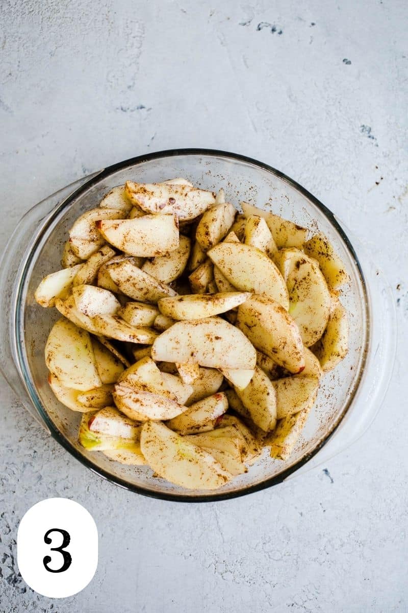 Raw apple slices coated in cinnamon and maple syrup.