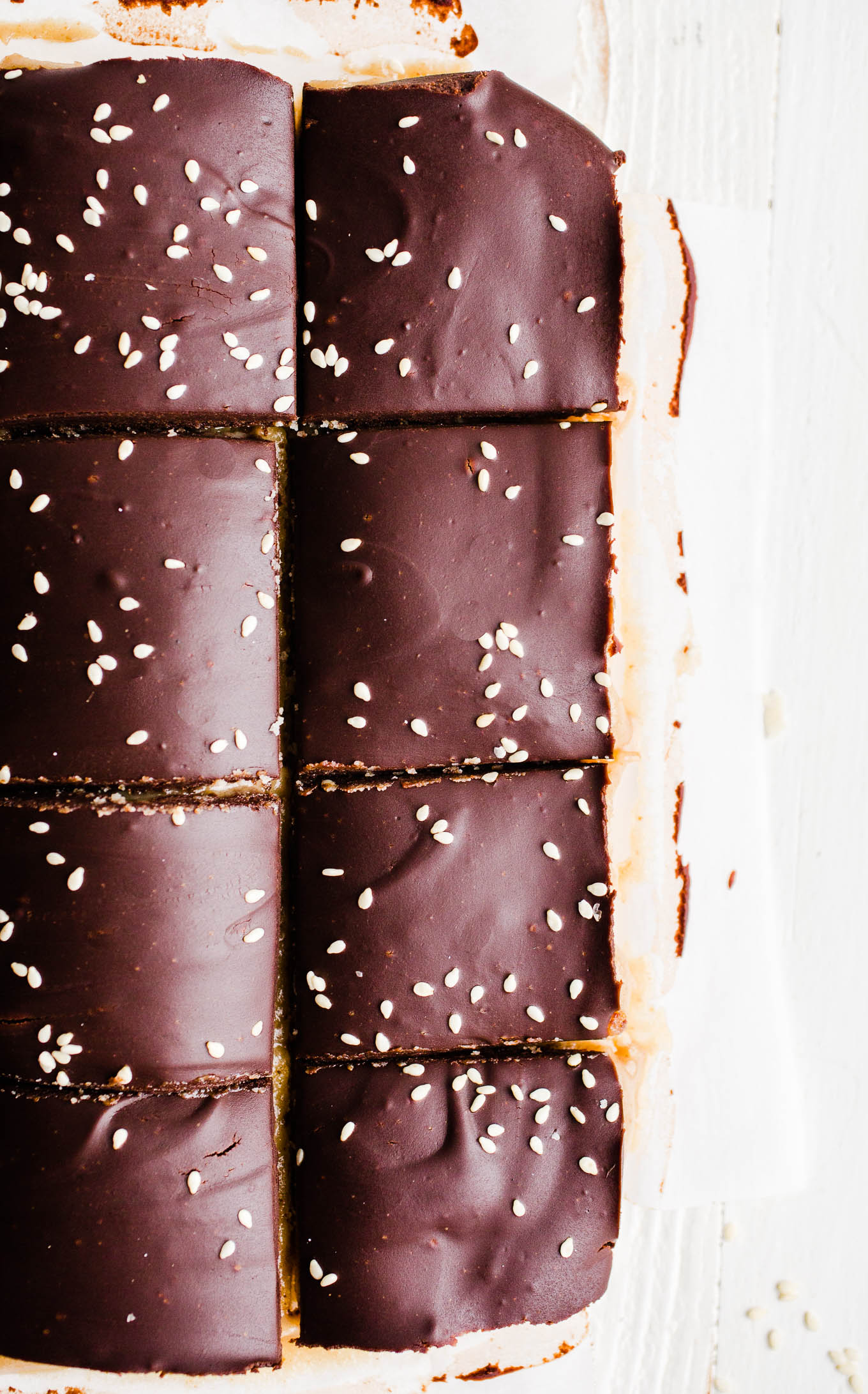 Dessert bars topped with chocolate and sesame seeds