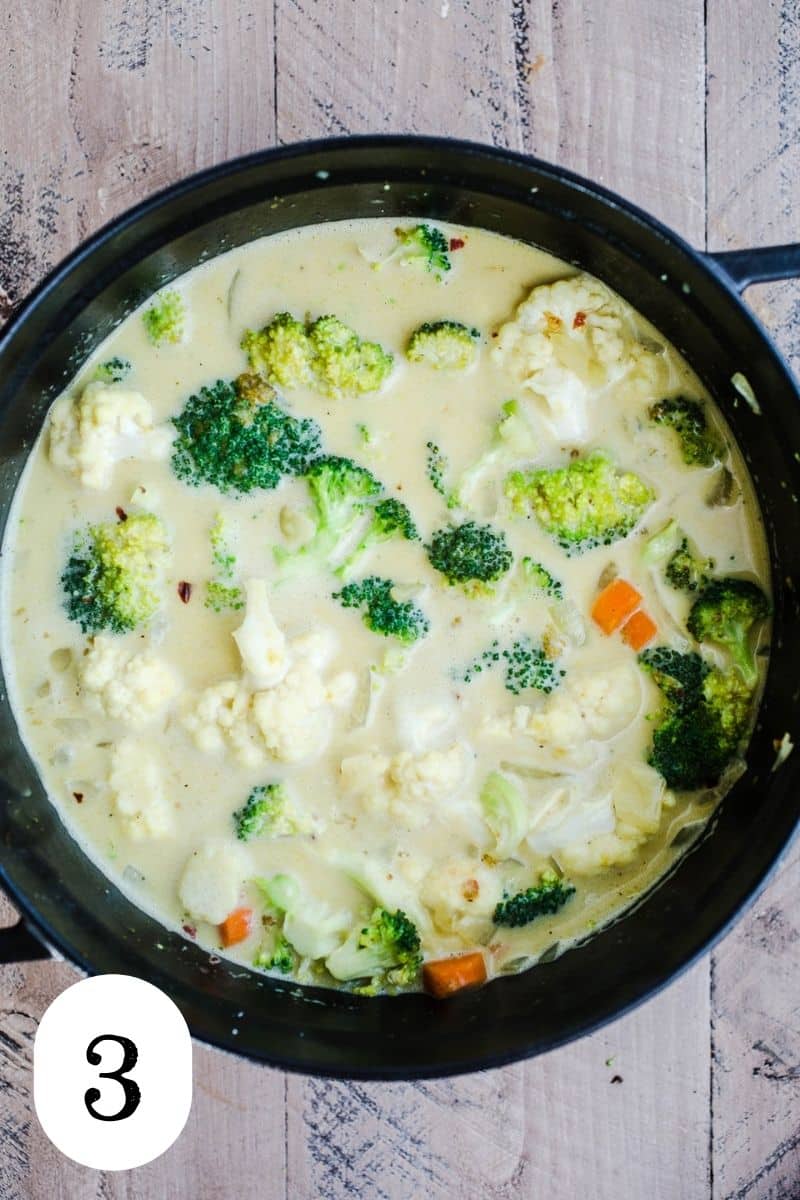 Cooked broccoli and cauliflower in a coconut milk broth.