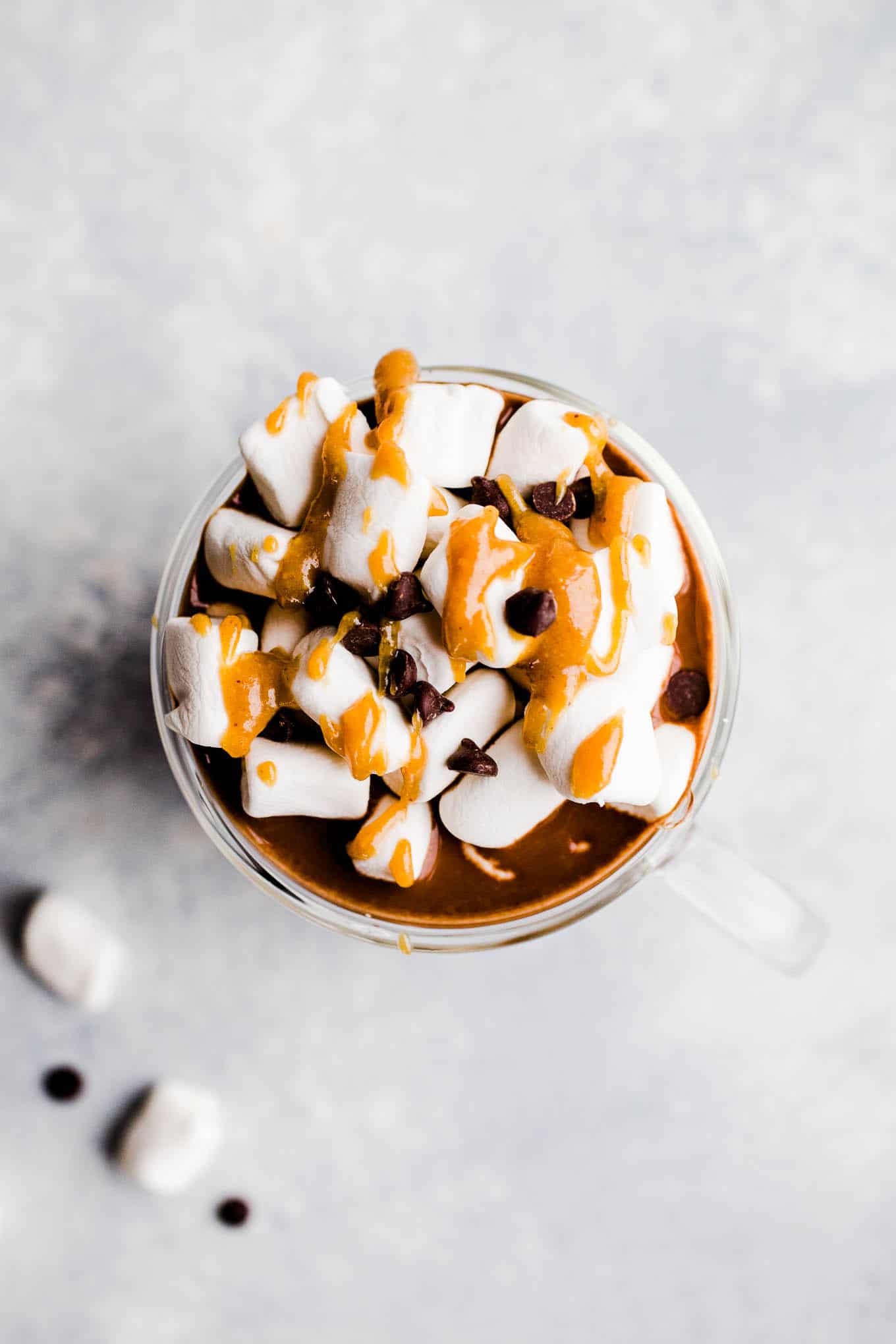 hot chocolate with marshmallows, chocolate chips, and peanut butter sauce