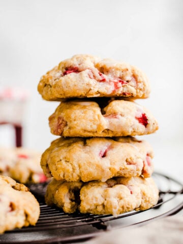 strawberry biscuits stacked on a cooling rack