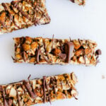 Nut and seed granola bars on a white surface.