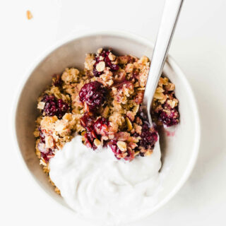 oats and blackberries with coconut whipped cream in bowl