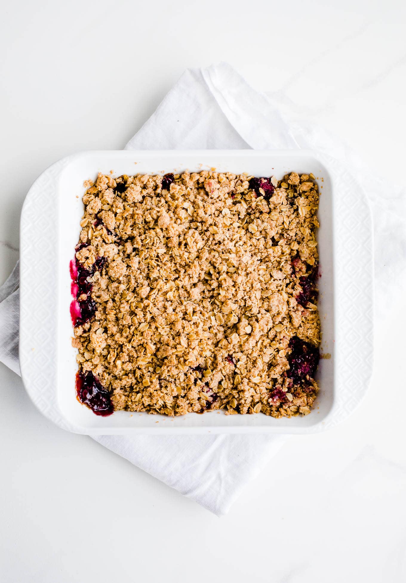 fruit topped with streusel in white dish