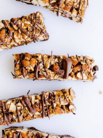 Nut and seed granola bars on a white surface.