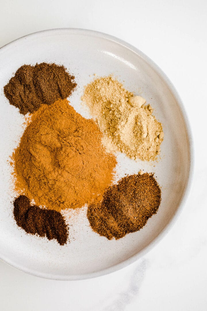 Five different spices on a plate.