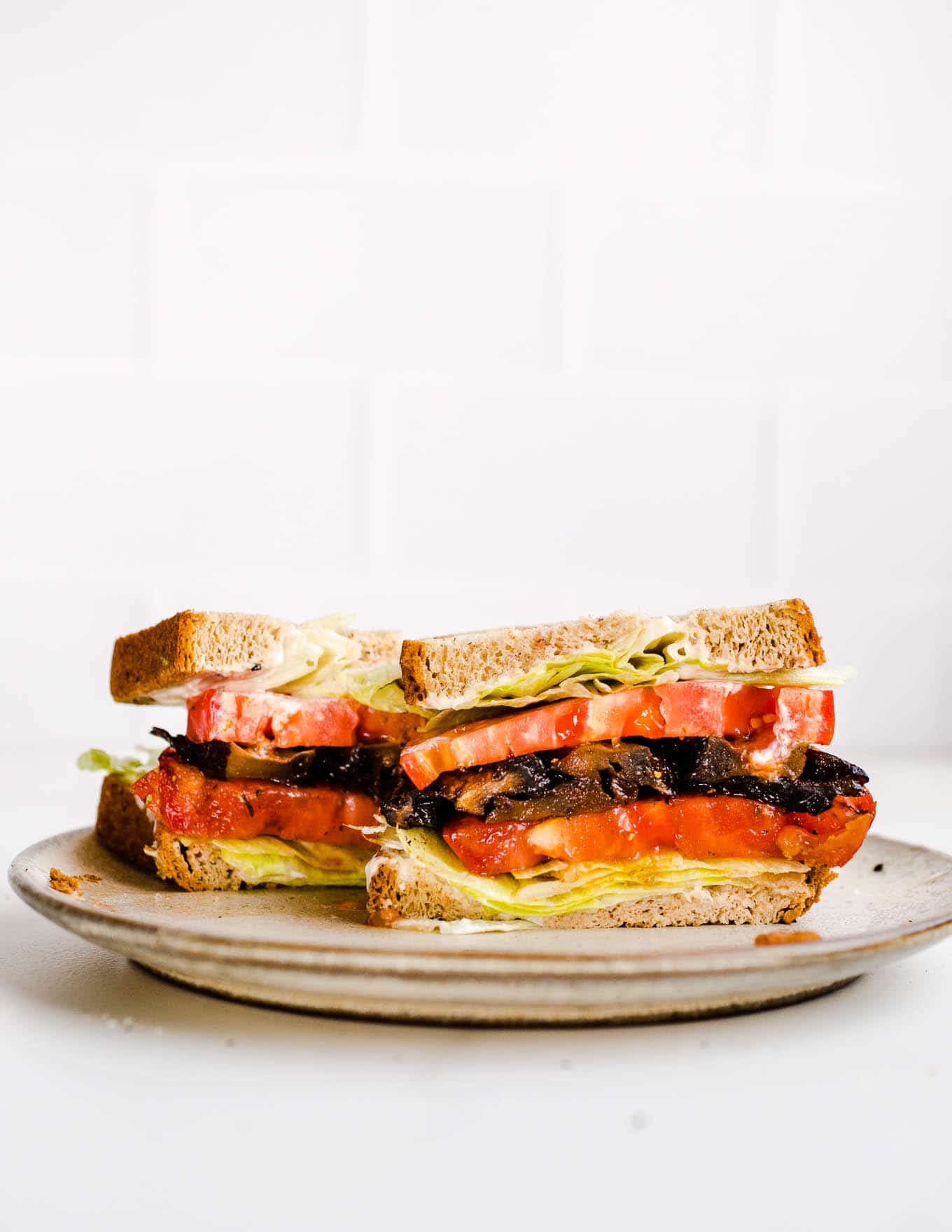 A vegan blt sandwich on plate.