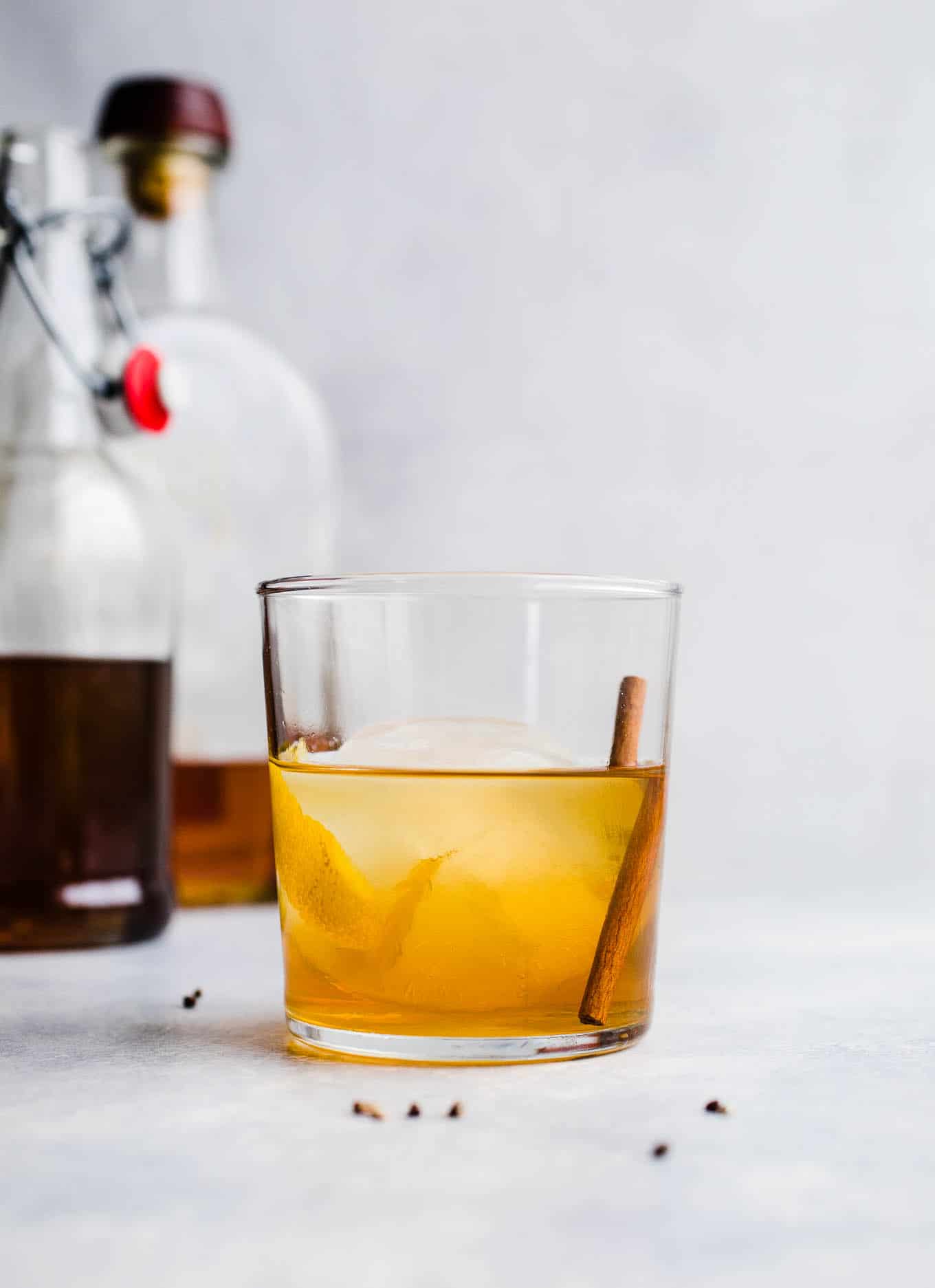 old fashioned cocktail with cinnamon stick and lemon peel
