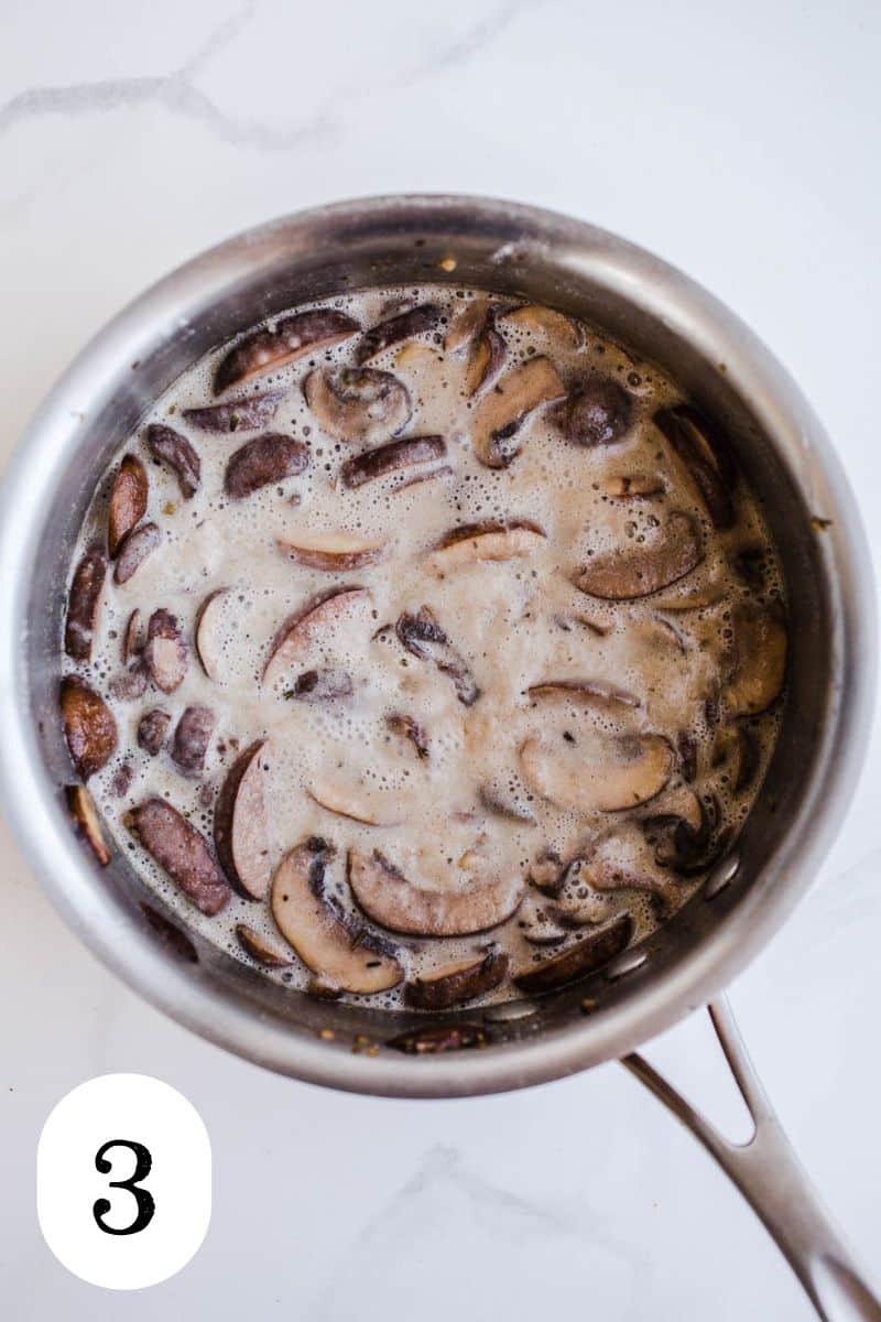Mushrooms cooked in a coconut milk in a medium saucepan.