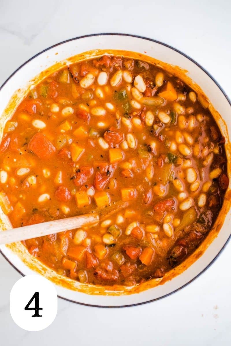 Simmered pumpkin chili in a large white pot.