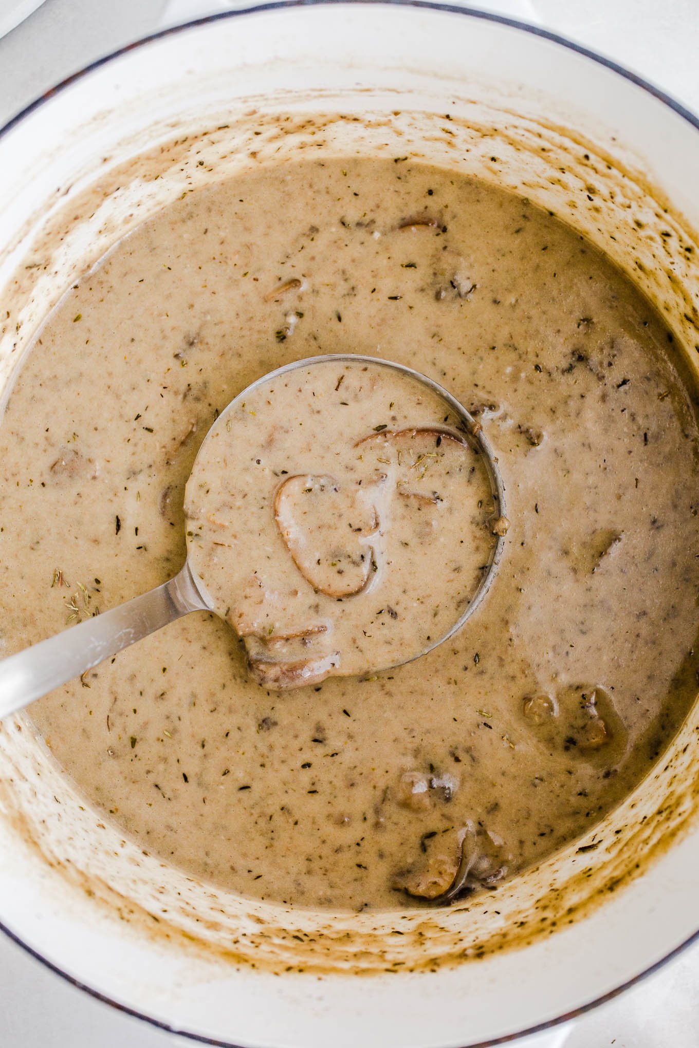 Pot of vegan cream of mushroom soup with bowl