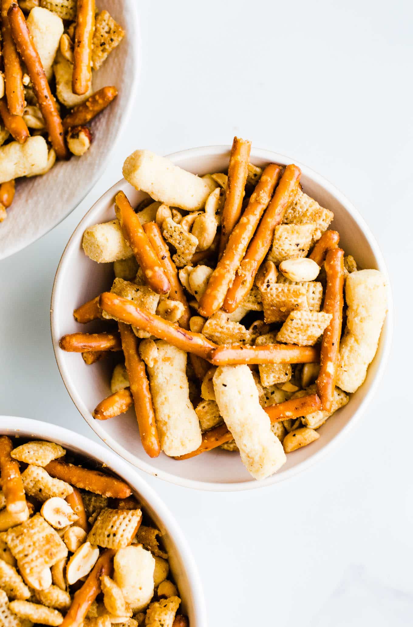 cheesy chex mix in white bowls