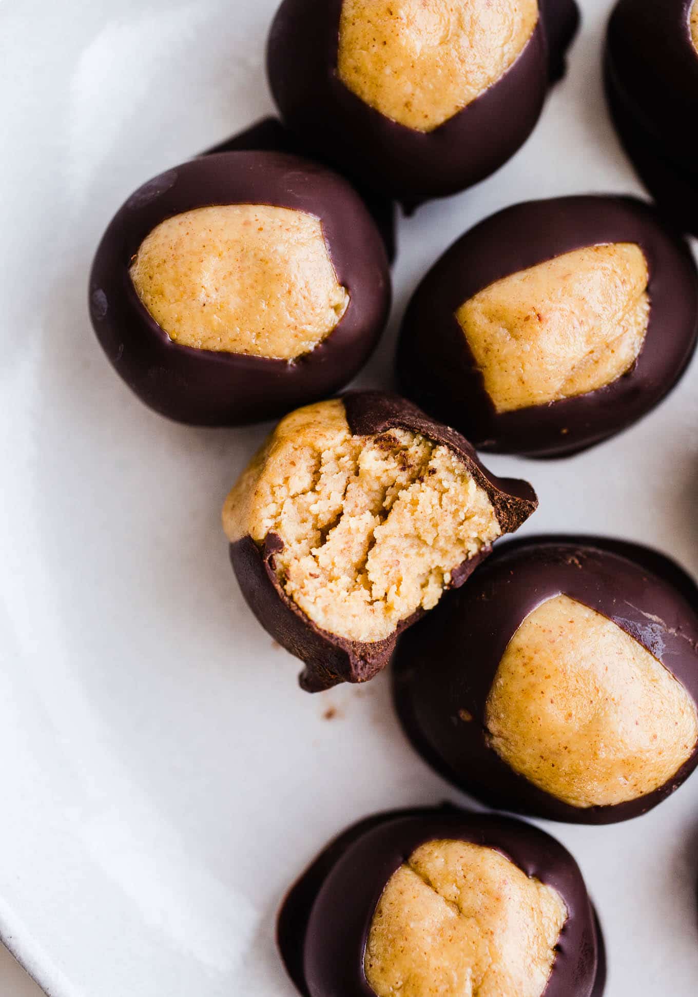 Peanut butter chocolate buckeye balls on a white plate.