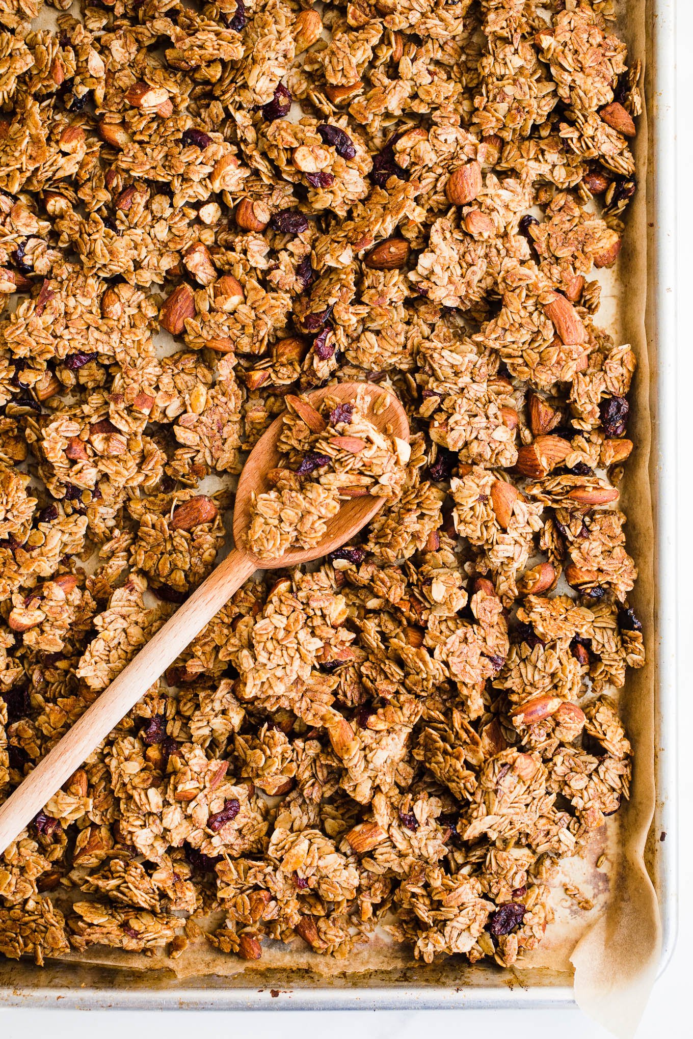 Freshly baked granola on a sheet pan.