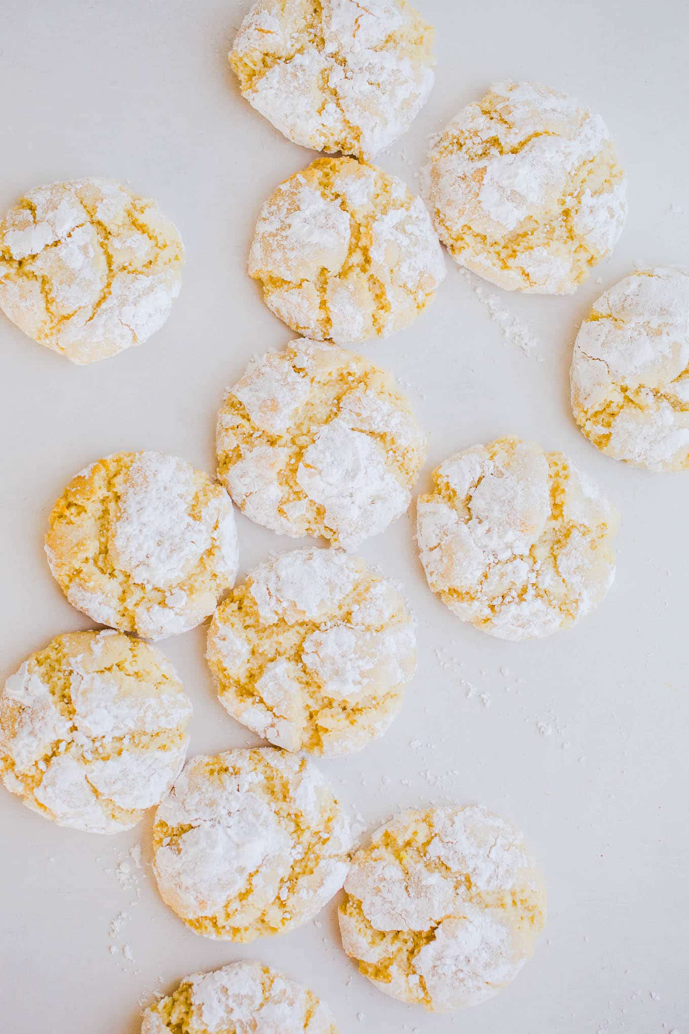 Lemon cookies with powdered sugar on parchment. 