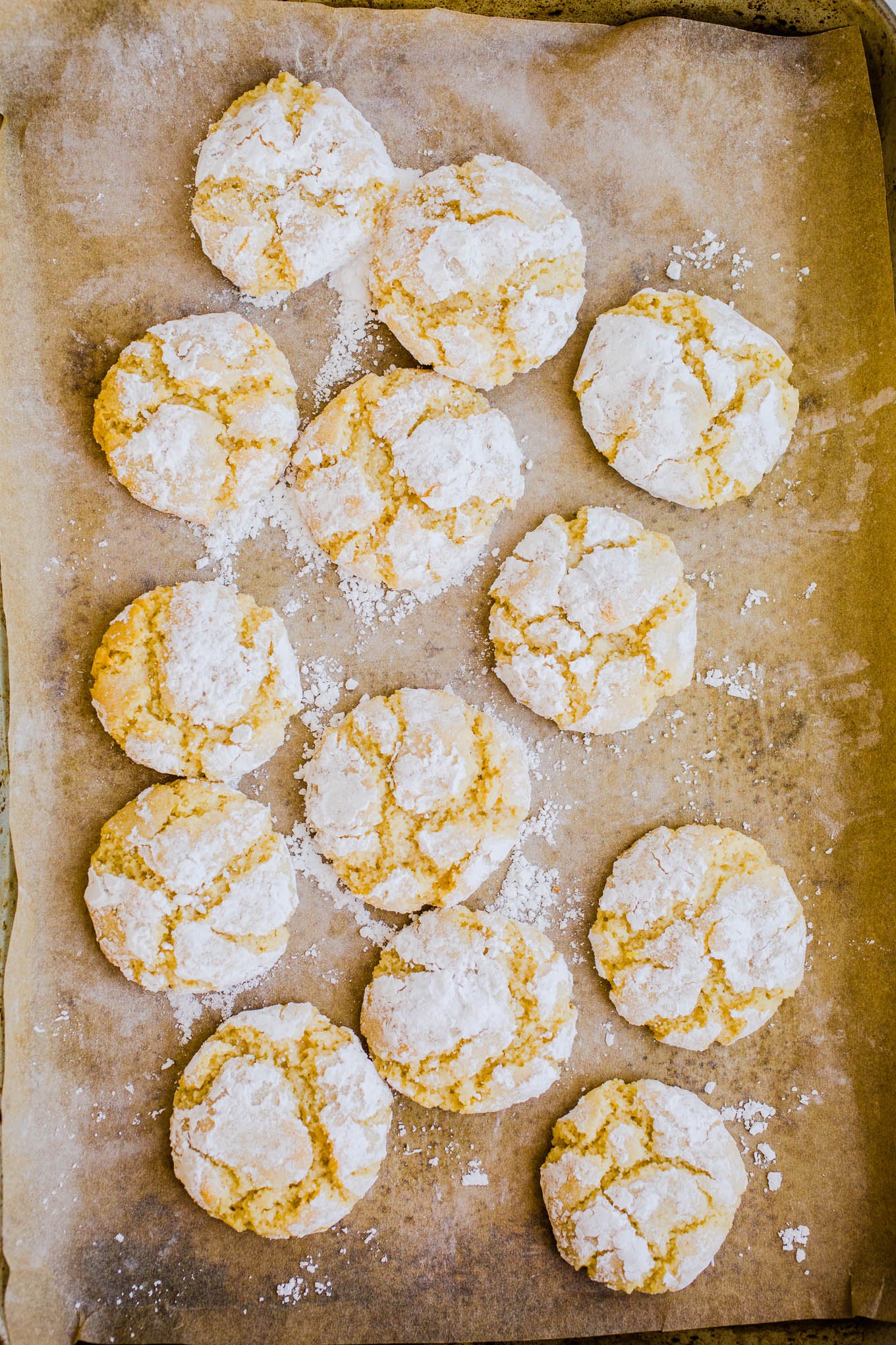 lemon crinkle cookies on parchment paper