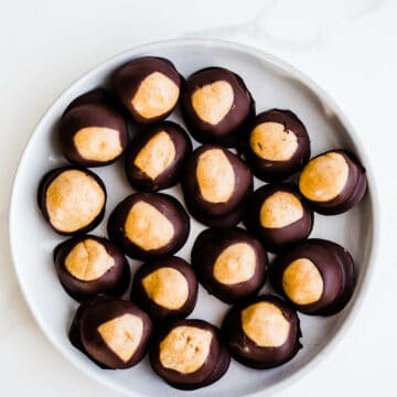 Peanut butter buckeyes on a white plate.
