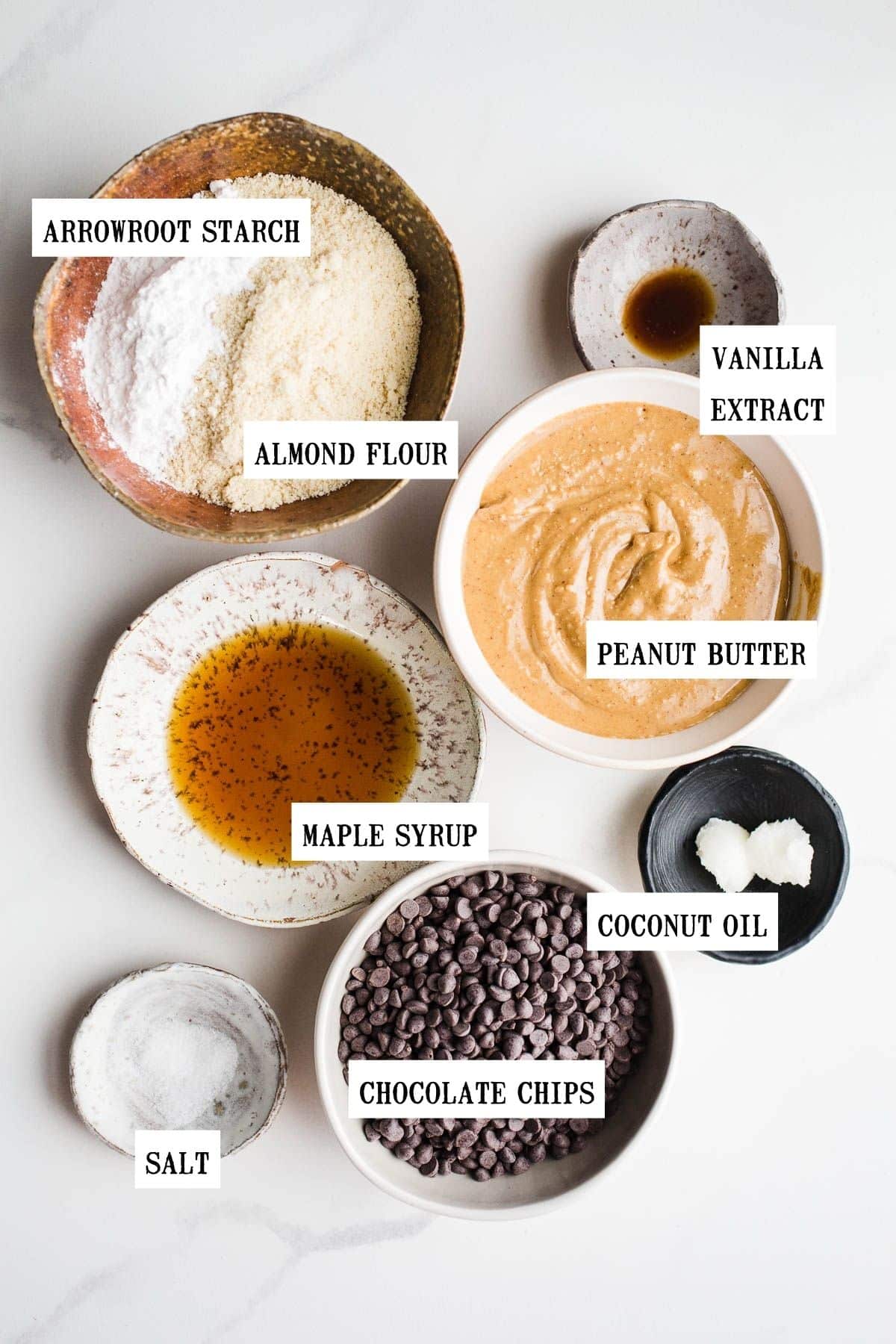 Ingredients to make peanut butter chocolate buckeye balls in separate bowls.
