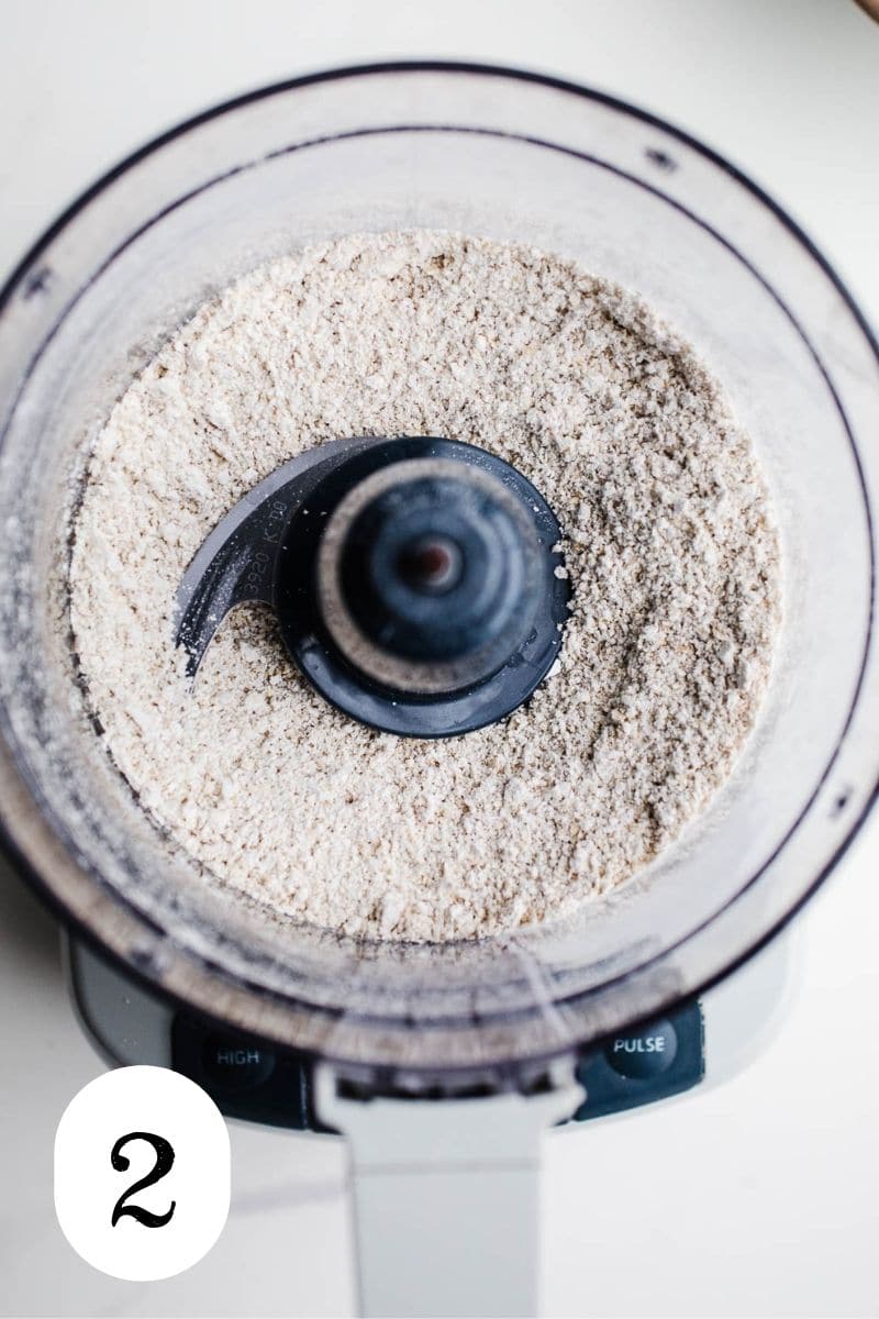 Oat flour in the bowl of a food processor. 