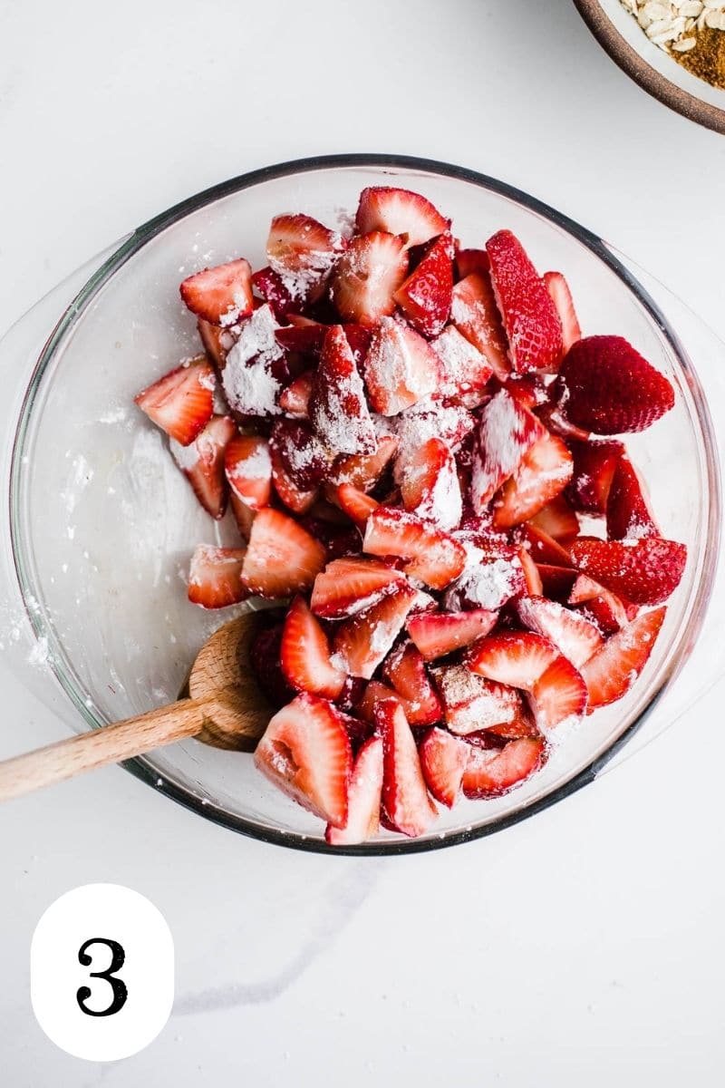 Sliced strawberries in glass bowl with arrowroot starch.