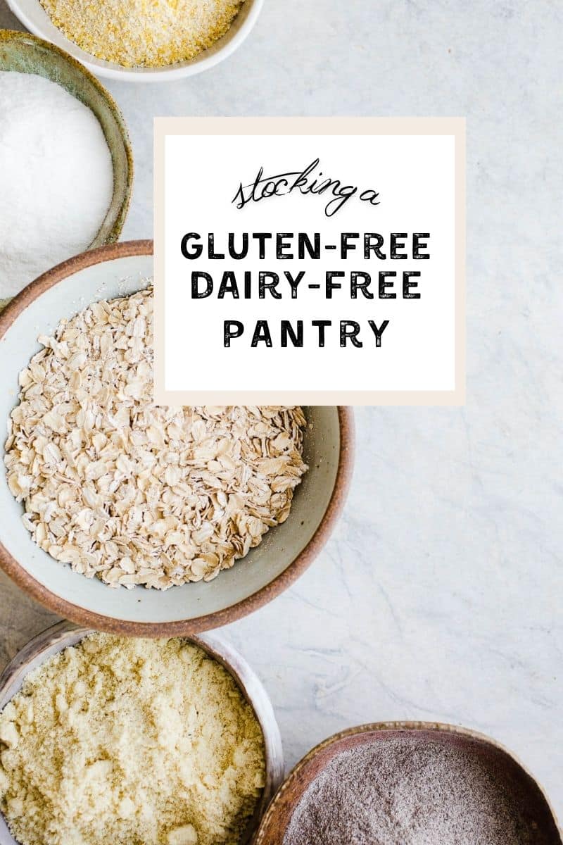 Oats, flours, and starches set out in different sized bowls on a gray surface.