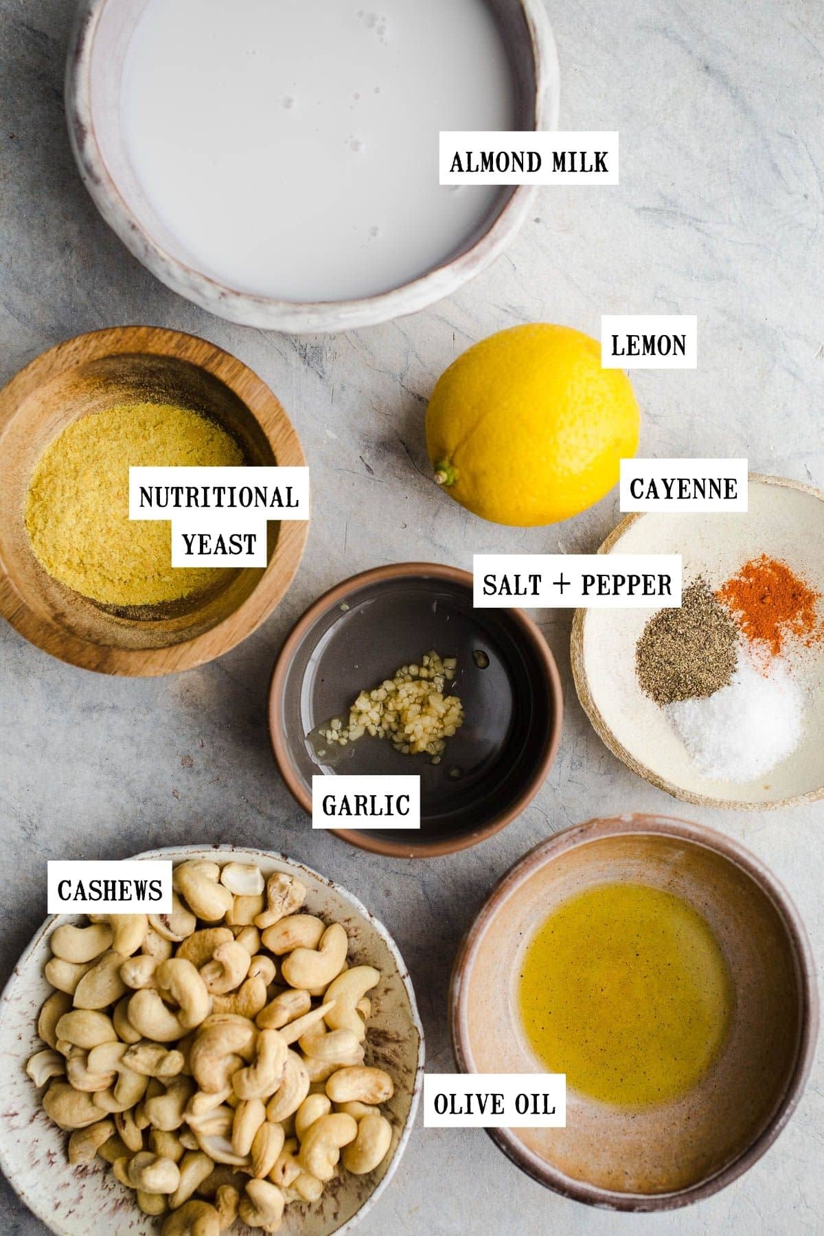 Ingredients for an Alfredo sauce in different size bowls.