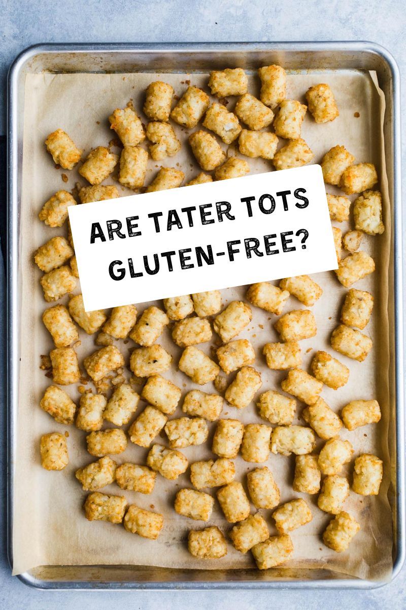 Baked tater tots on a parchment lined baking pan.