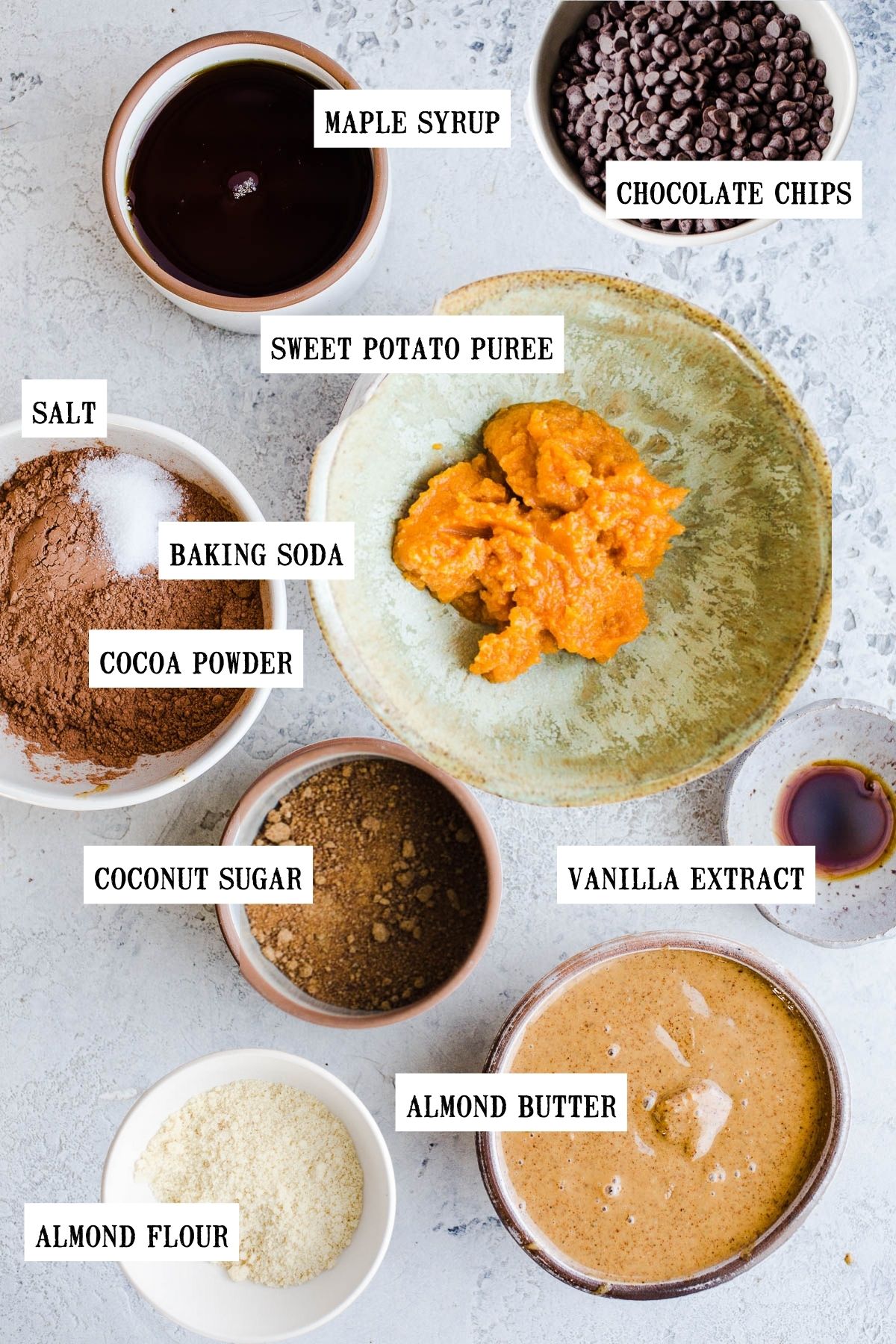 Ingredients to make vegan brownies in bowls of different sizes.