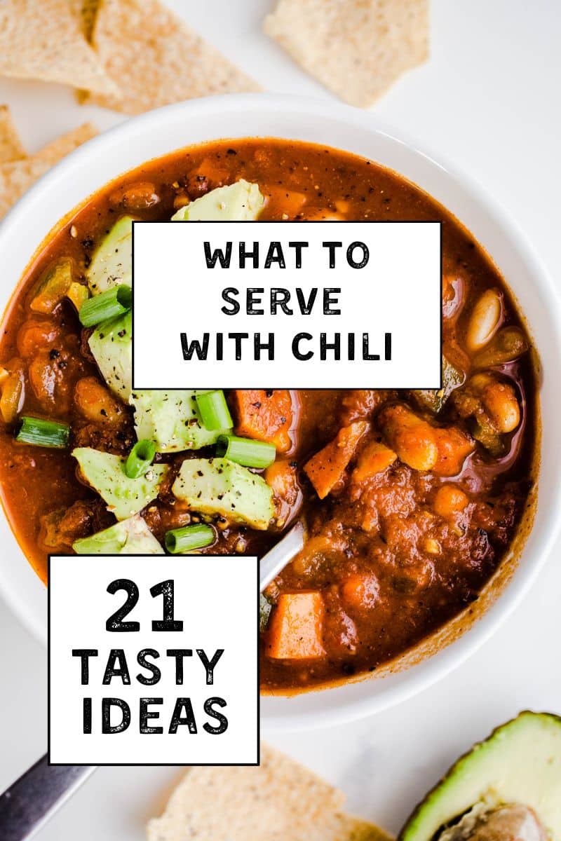 A bowl of chili topped with avocado and black pepper.