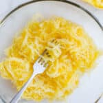 Yellow veggie noodles in a glass bowl.