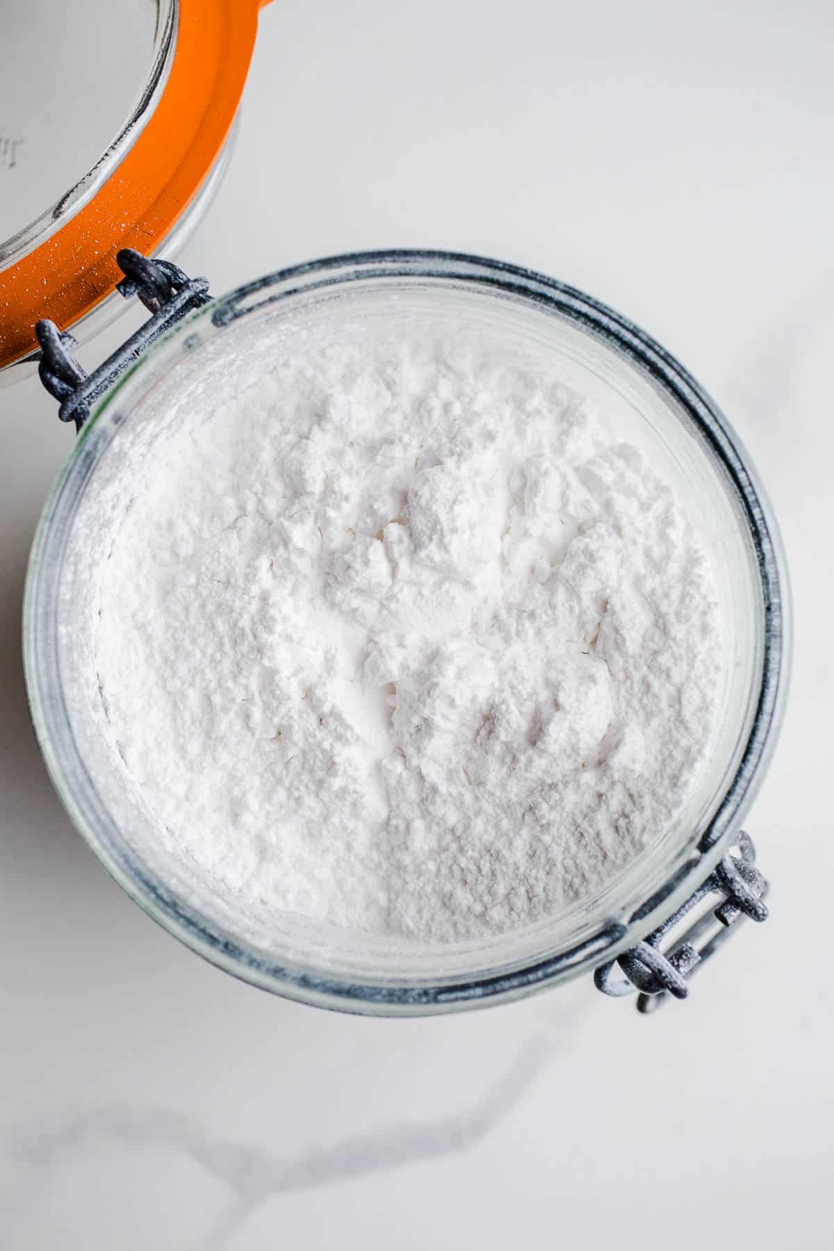 A glass mason jar filled with arrowroot starch.