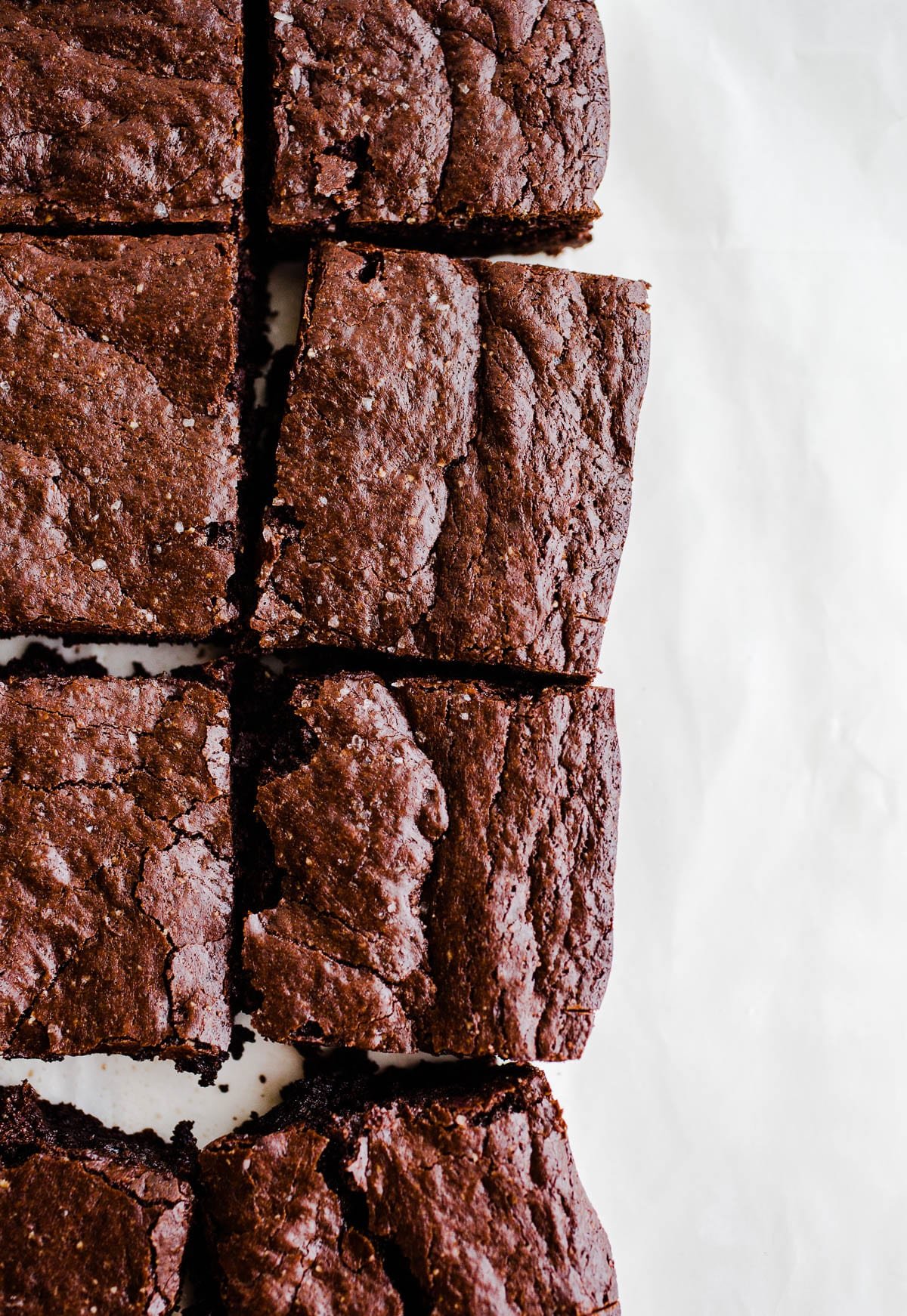 Edge brownies on a piece of parchment paper.