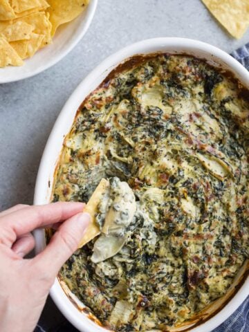 Spinach dip in a white dish.